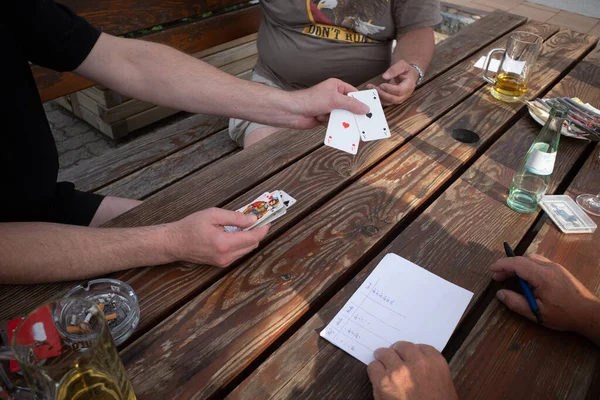 at a table cards are played and the points are written down