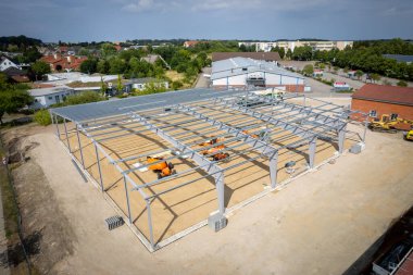 a steel scaffold for a warehouse is erected on a construction site