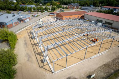 a steel scaffold for a warehouse is erected on a construction site