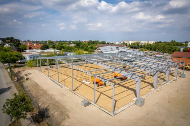 a steel scaffold for a warehouse is erected on a construction site