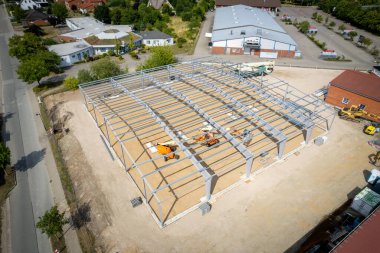 a steel scaffold for a warehouse is erected on a construction site