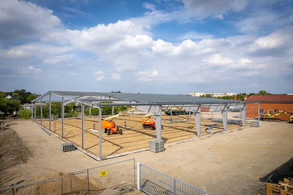 a steel scaffold for a warehouse is erected on a construction site