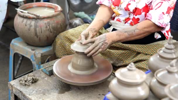 Close up of hands making earthen jar on a wheel in traditional Thailand style — Stock Video