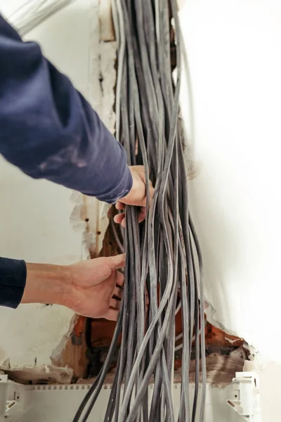 Electrical wires in the electrical panel. Repair in the apartment. Connecting the light. Professional installation of electrical outlets, wires and switches