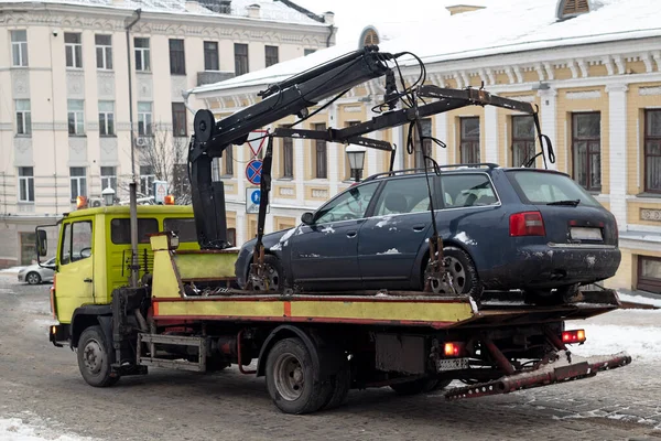 Kyiv, Ukraine: Loading car on to tow truck. Evacuation of the parking intruder\'s car