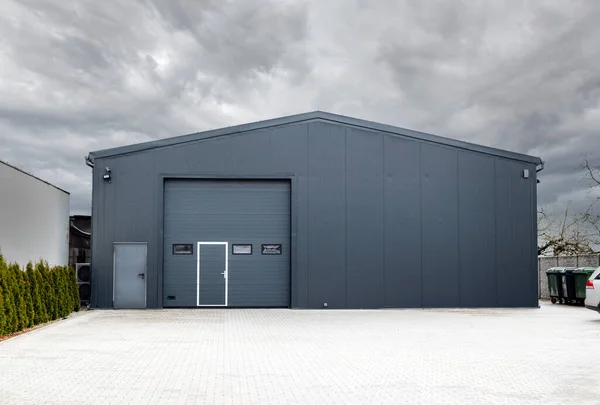 Metallic black garage with roller doors, industrial warehouse. High quality photo