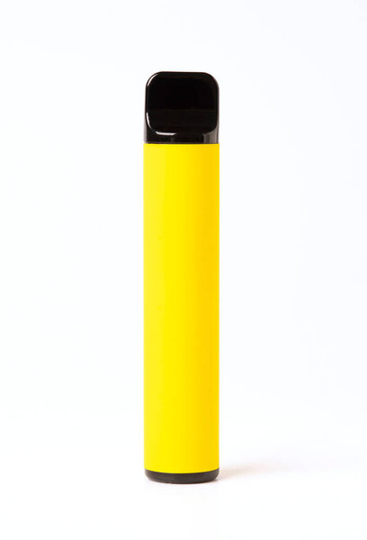 Yellow disposable electronic cigarette isolated on a white background. The concept of modern smoking, vaping and nicotine
