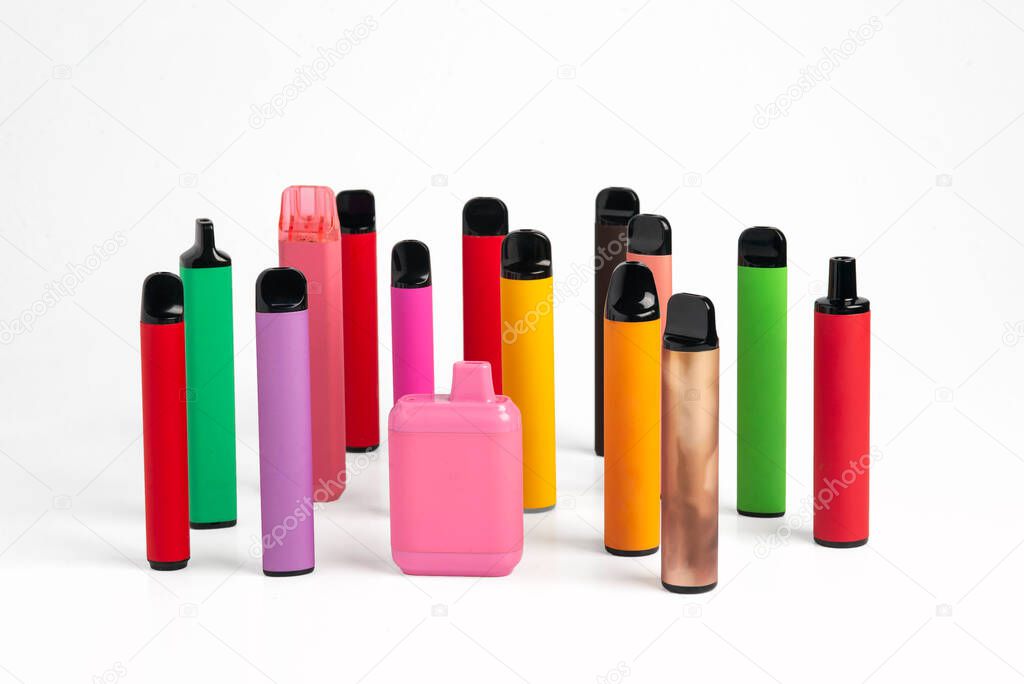 Set of colorful disposable electronic cigarettes of different shapes on a white background. The concept of modern smoking. High quality photo