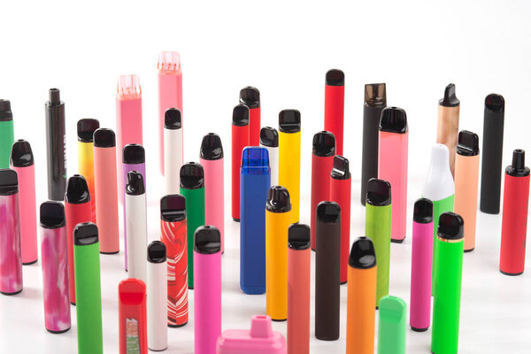 Set of colorful disposable electronic cigarettes of different shapes on a white background. The concept of modern smoking