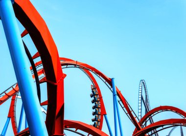 looping roller coaster on blue sky sunny day