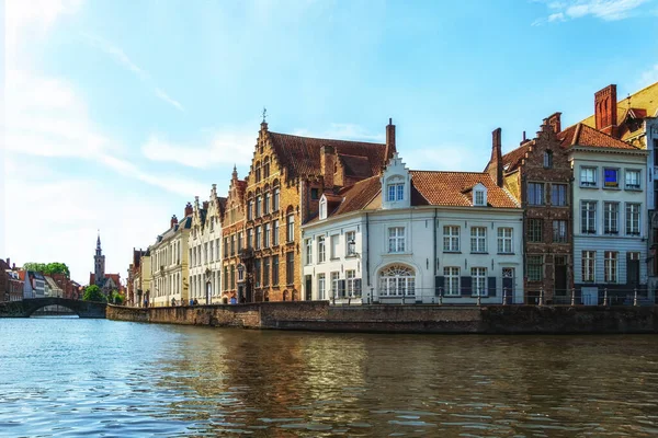 stock image Panorama with canal, cathedral tower and colorful traditional houses against blue sky in popular belgian destination, Brugge