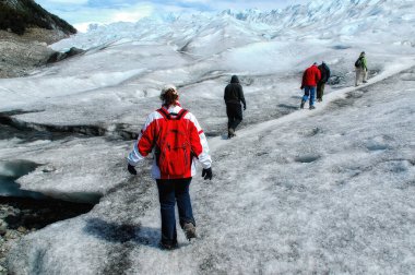 Tourists trekking on Perito Moreno Glacier in Los Glaciares National Park near El Calafate in Argentina, Patagonia, South America.