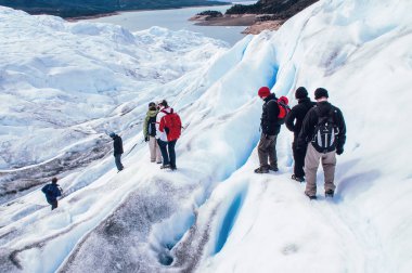 Tourists trekking on Perito Moreno Glacier in Los Glaciares National Park near El Calafate in Argentina, Patagonia, South America.