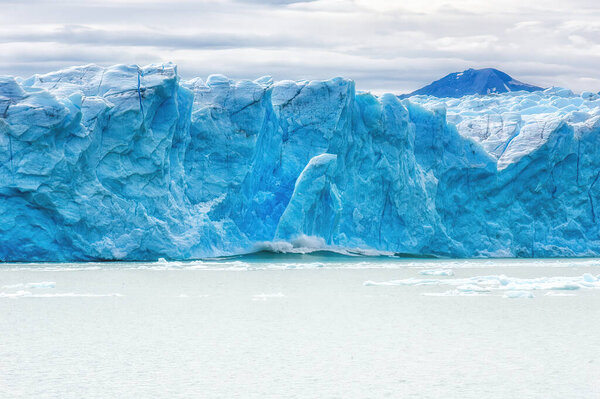 Ice Calving: A giant chunk of ice breaking off the magnificent Perito Moreno Glacier in Patagonia, Argentina.