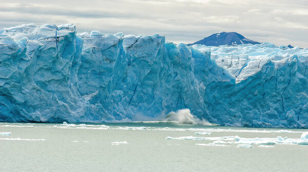 Ice Calving: A giant chunk of ice breaking off the magnificent Perito Moreno Glacier in Patagonia, Argentina.