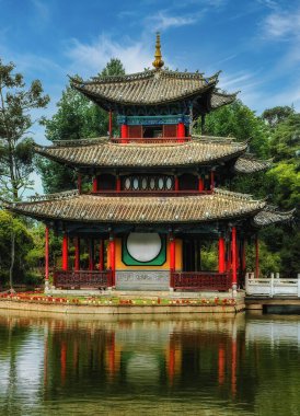 View of a beautiful ancient chinese pavilion in the black dragon pond in Lijiang which is one of the most popular tourist spots in China