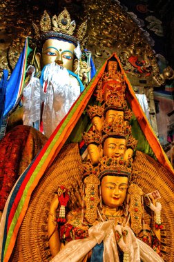 Statue the Buddhist master Guru Rinpoche who has brought the Buddhism to Tibet located in Jokhang Buddhist temple in Lhasa. On a breast it is written in Tibetan: 