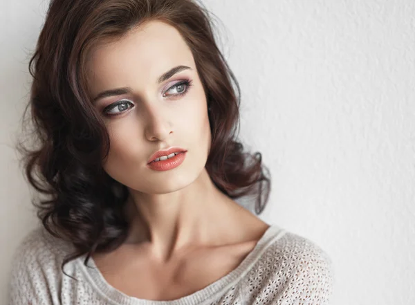 Portrait of the beautiful young fashionable girl with brown hair