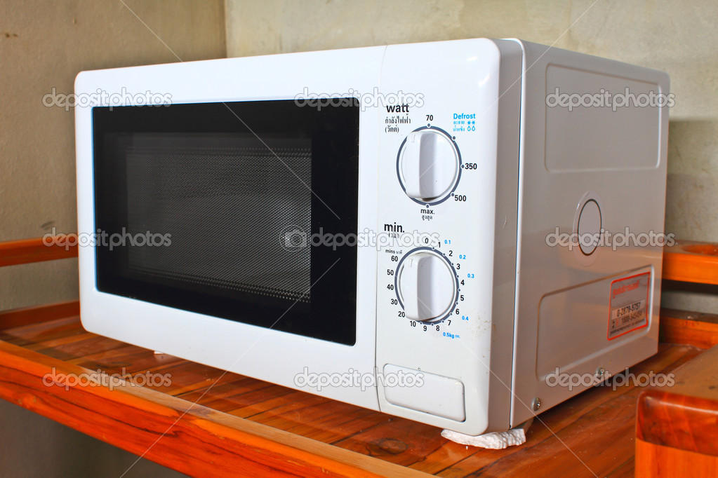 Microwave oven on the table — Stock Photo © sirichai2514 34253913