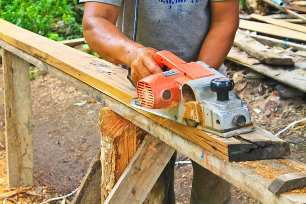 Hand carpenter using wood planer — Stock Photo, Image