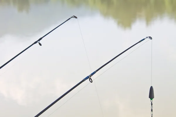 Fishing rods on riverside — Stock Photo, Image