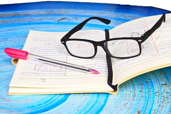 Glasses, notebook and pen on the homework — Stock Photo, Image