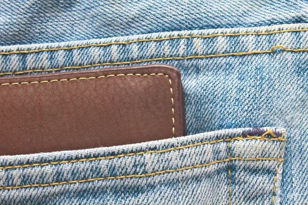 Brown wallet in jeans trousers back pocket — Stock Photo, Image