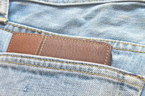 Brun plånbok i jeans byxor bakficka Stockbild
