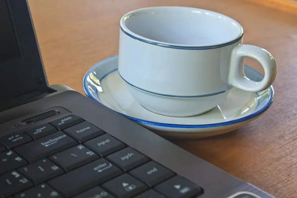 Coffee cup and laptop  on table — Stock Photo, Image