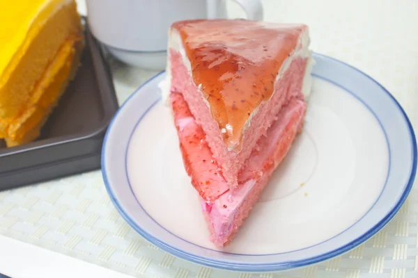 Orange Cheesecake with Strawberry cheesecake in plate on backgro — Stock Photo, Image