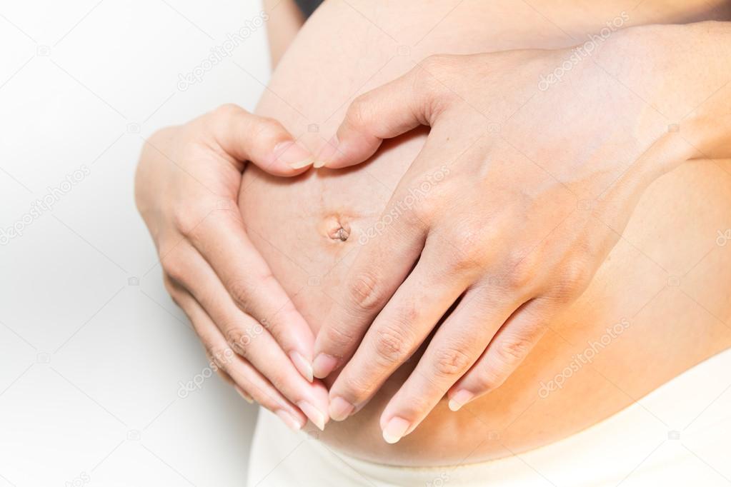 Close up a heart shaped pregnancy of Asian Women