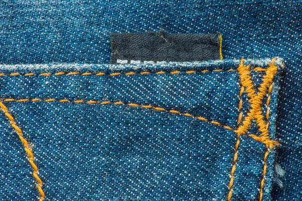 Label en blauwe Denim Jean textuur achtergrond — Stockfoto