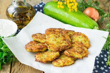 Tahta arka planda tavada kızarmış patates gözlemesi ve kabak.