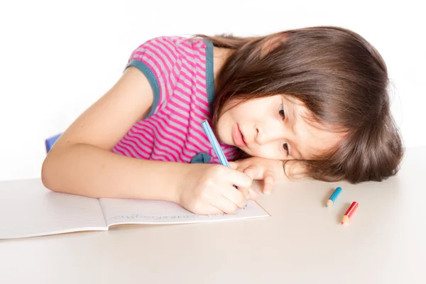 Child writing at desk — Stock Photo, Image