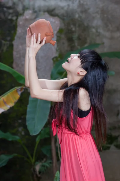 Asyalı kız kil pot içiyor — Stok fotoğraf