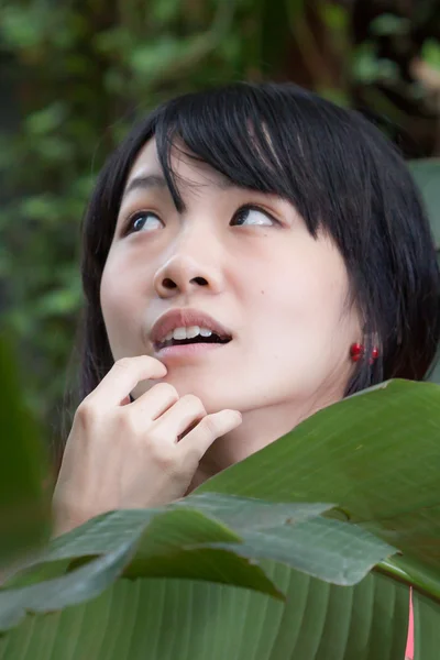 Asian girl by plants — Stock Photo, Image