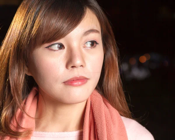 Pretty Asian woman with city lights in background — Stock Photo, Image