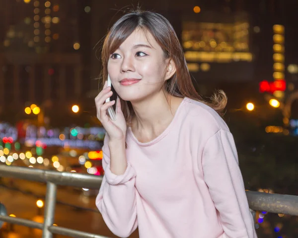 Beautiful young Asian woman with cellphone — Stock Photo, Image