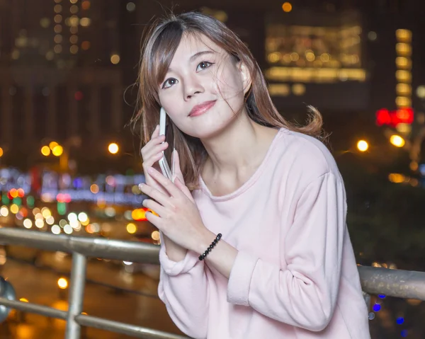 Beautiful young Asian woman with cellphone — Stock Photo, Image