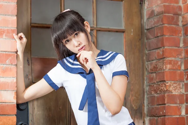 Asian schoolgirl in uniform outside school — Stock Photo, Image