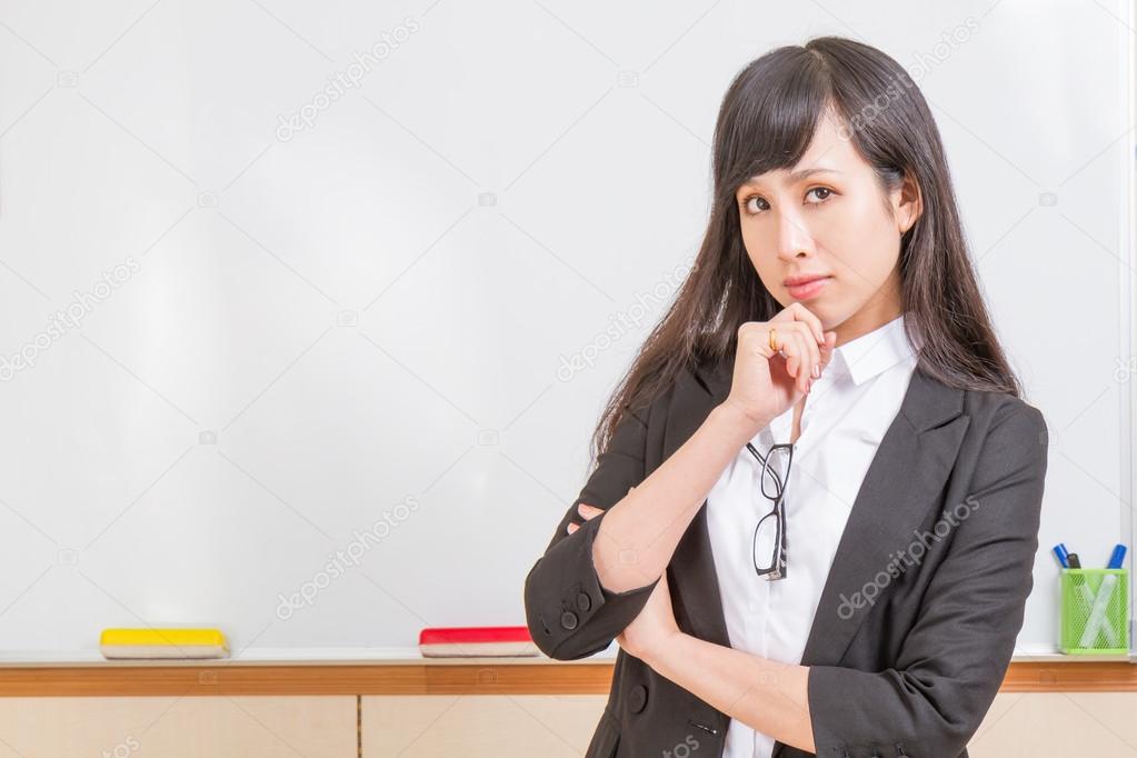 Asian teacher in front of whiteboard