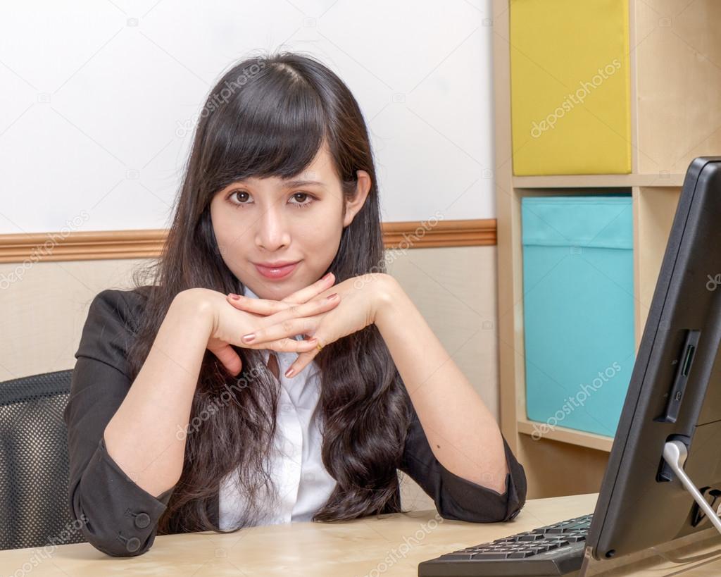 Chinese Businesswoman sitting at desk 