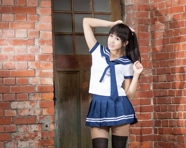 Asian schoolgirl standing in front of school — Stock Photo, Image