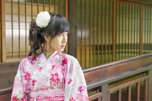 Mujer asiática vistiendo una yukata frente a ventanas de estilo japonés —  Fotos de Stock