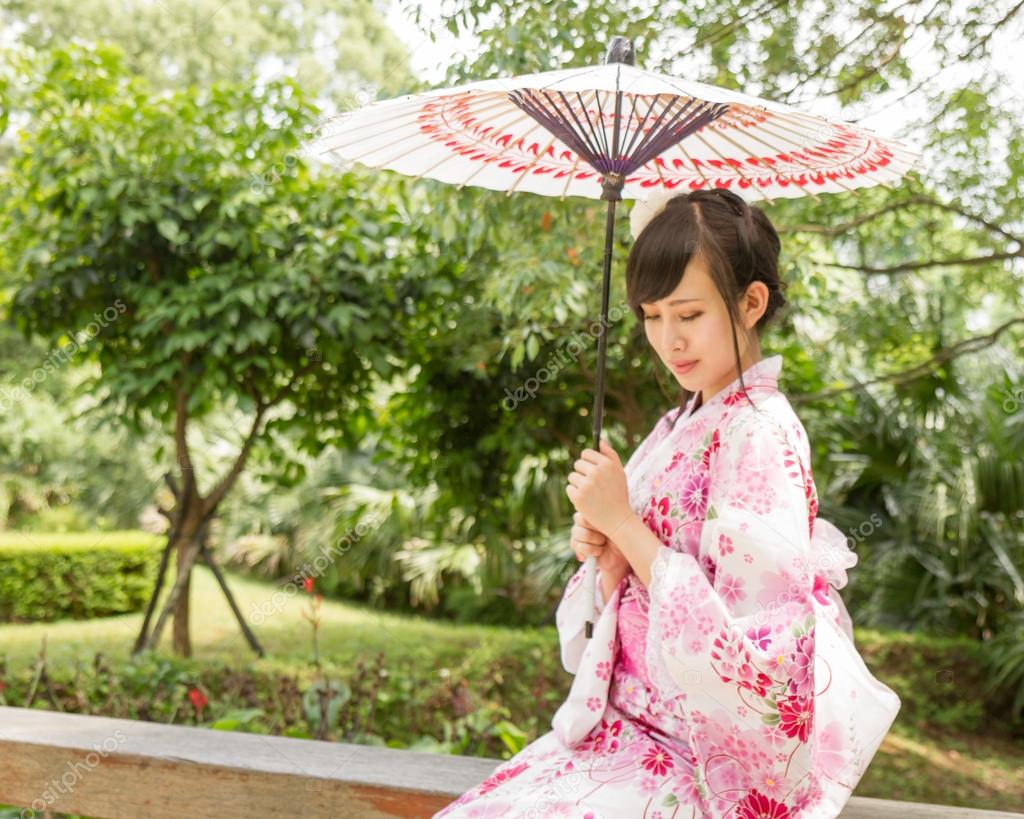 Asian woman wearing a yukata with an umbrella in Japanese style 