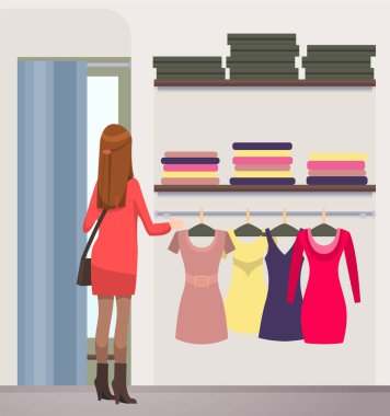 Girl chooses outfit in wardrobe at home or in boutique. Lady in dress chooses garment while shopping