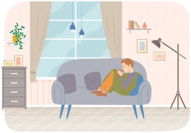 Kanepede oturan bir adam evde çay ya da kahve içiyor. İnsan evde yalnız vakit geçirir.