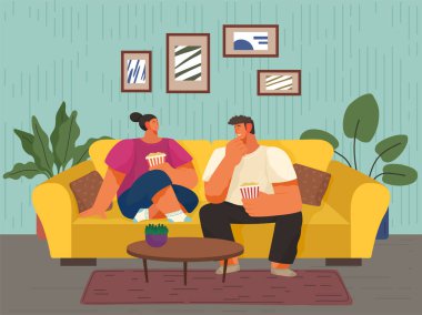 İki kadın ve bir adam evlerinde kanepede oturup konuşuyor ve birlikte patlamış mısır yiyorlar. Erkek ve kadın karakter evlerinde atıştırmalıklarla kanepede dinleniyor. Mutlu aile eğlencesi oturma odasında