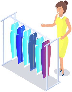 Choosing clothes in store, shopping concept. Female buyer chooses clothing in dressing room. Customer with dress hanging on hanger in mall. Woman shopper stands in fitting room of store or boutique