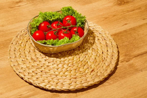 Tomate with salad on a basket — Stock Photo, Image